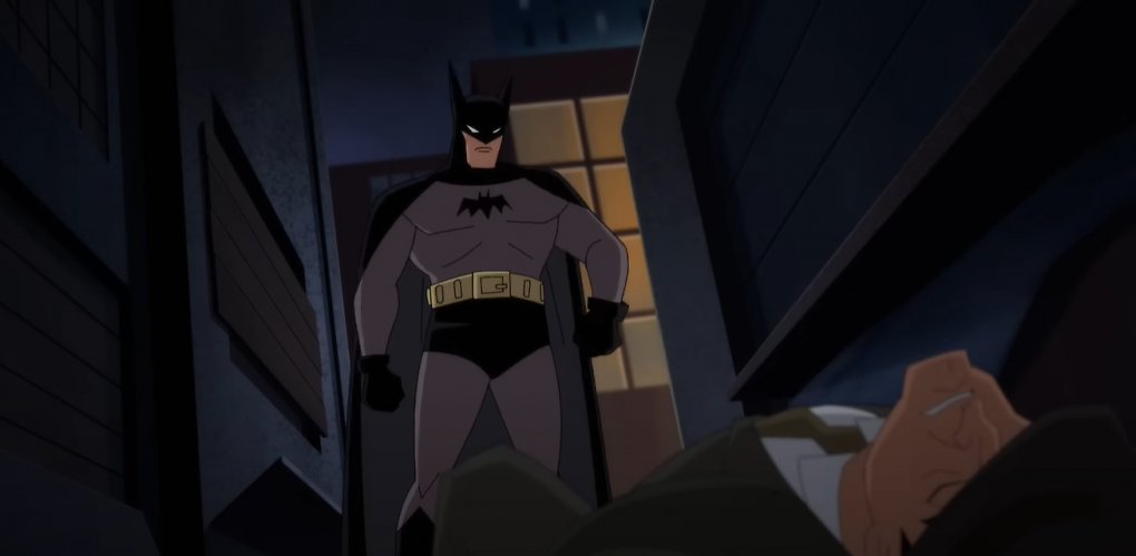 Batman steht vor einem zu Boden gegangenen Verbrecher.