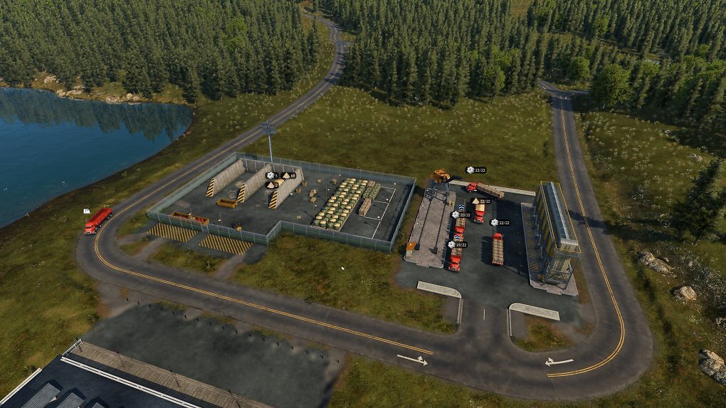Hier werden Waren von einem Hafen (am unteren Bildrand) auf Trucks umgeschlagen. Auf der linken Seite ist das dazu benötigte Lagerhaus.