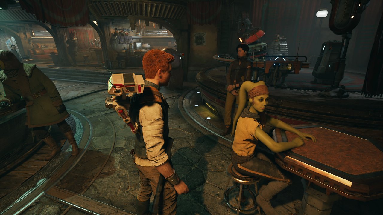 Cal unterhält sich in einer Cantina mit einer Twi'Lek.